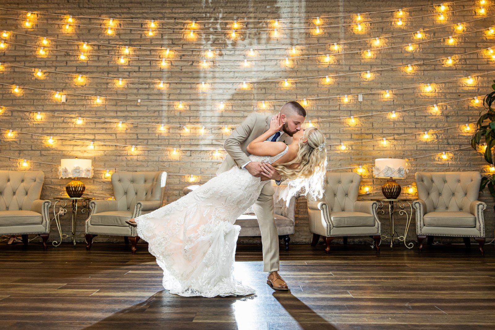 First dance dip under string lights at a Falls Manor wedding, Bristol, Bucks County