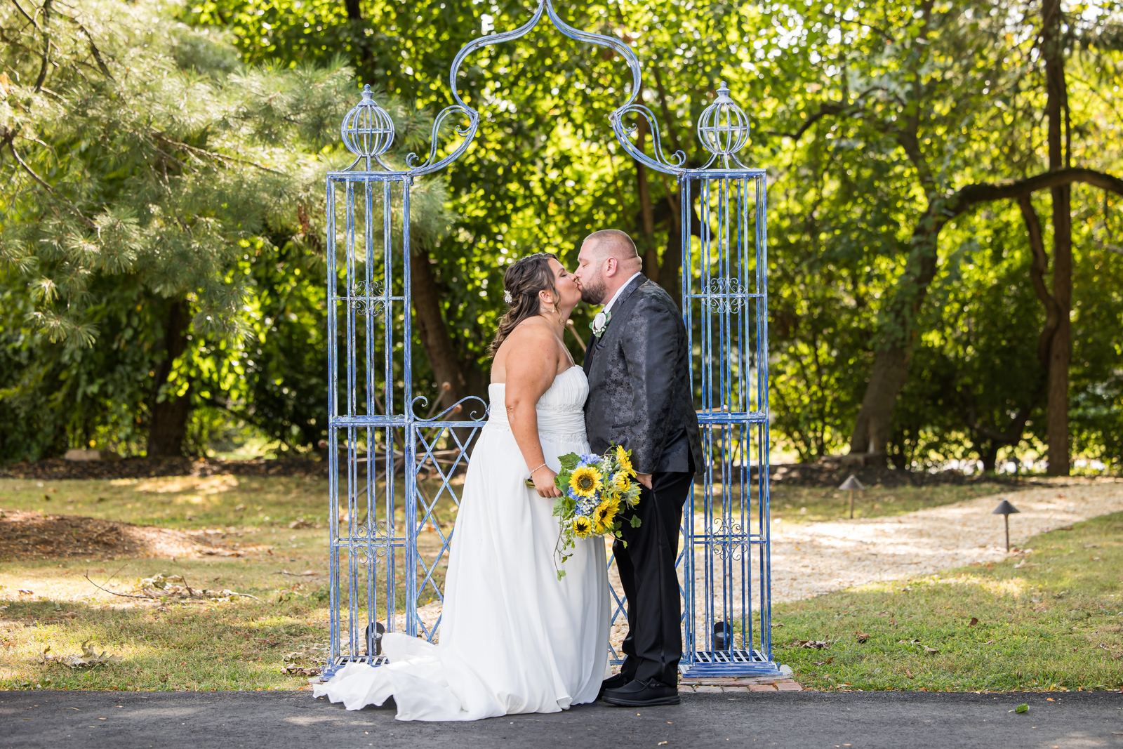 Couple kissing under the garden arbor at La Luna Banquet Hall in Bensalem, Bucks County