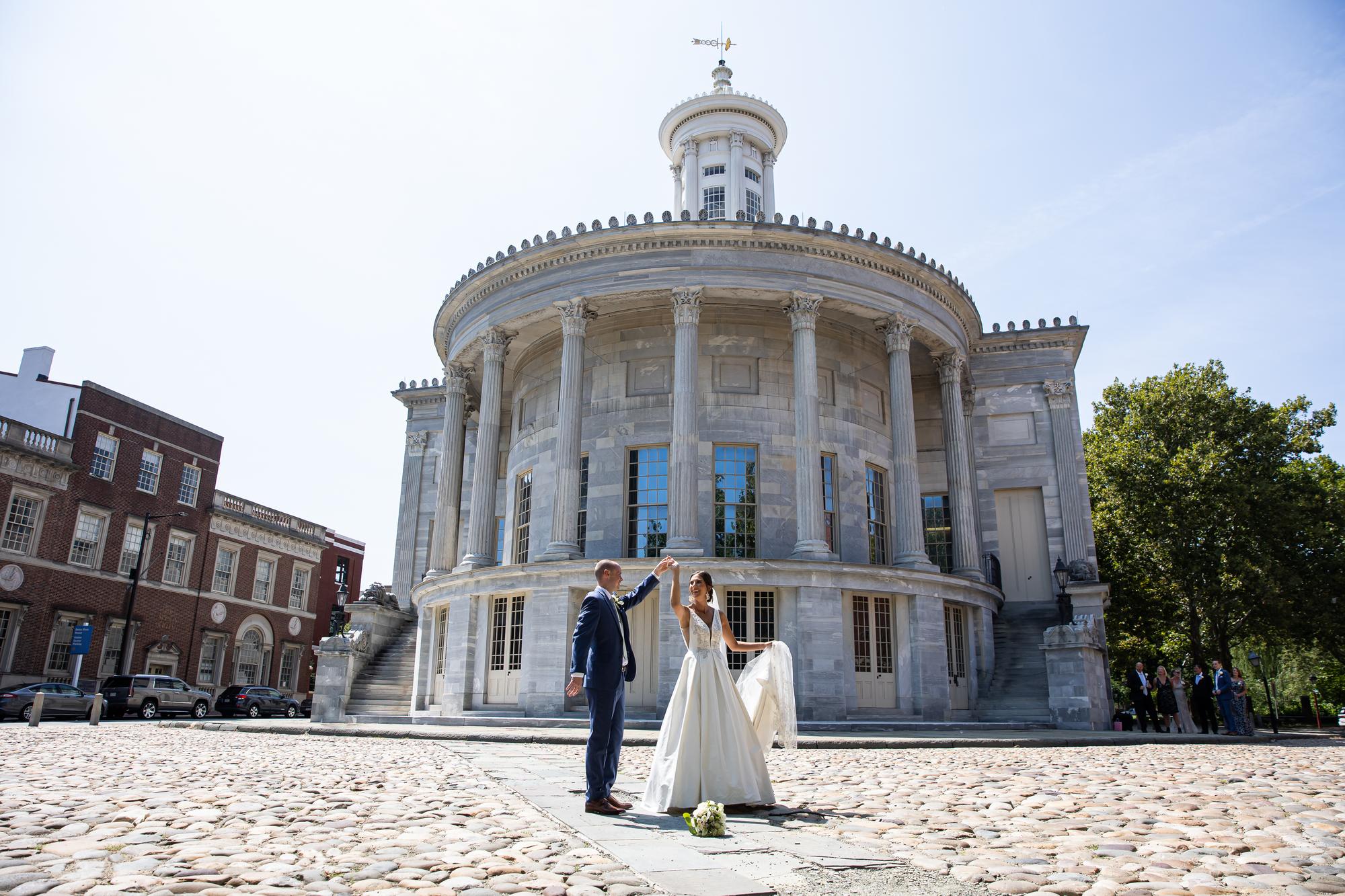 Couple dancing on the cobblestones in front of the Merchants' Exchange building, Old City Philadelphia