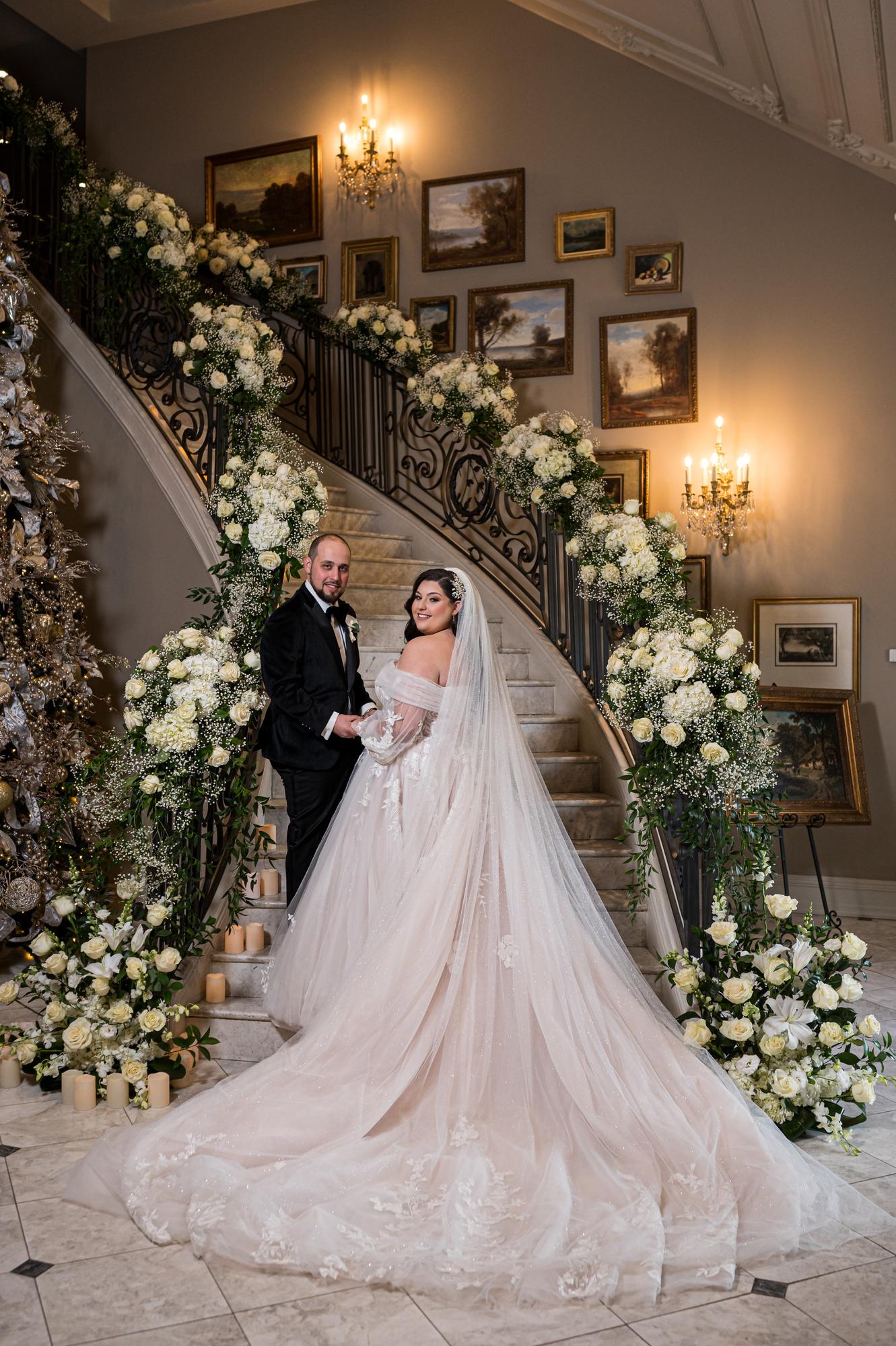 Bride on the floral staircase at Park Chateau Estate in East Brunswick, New Jersey