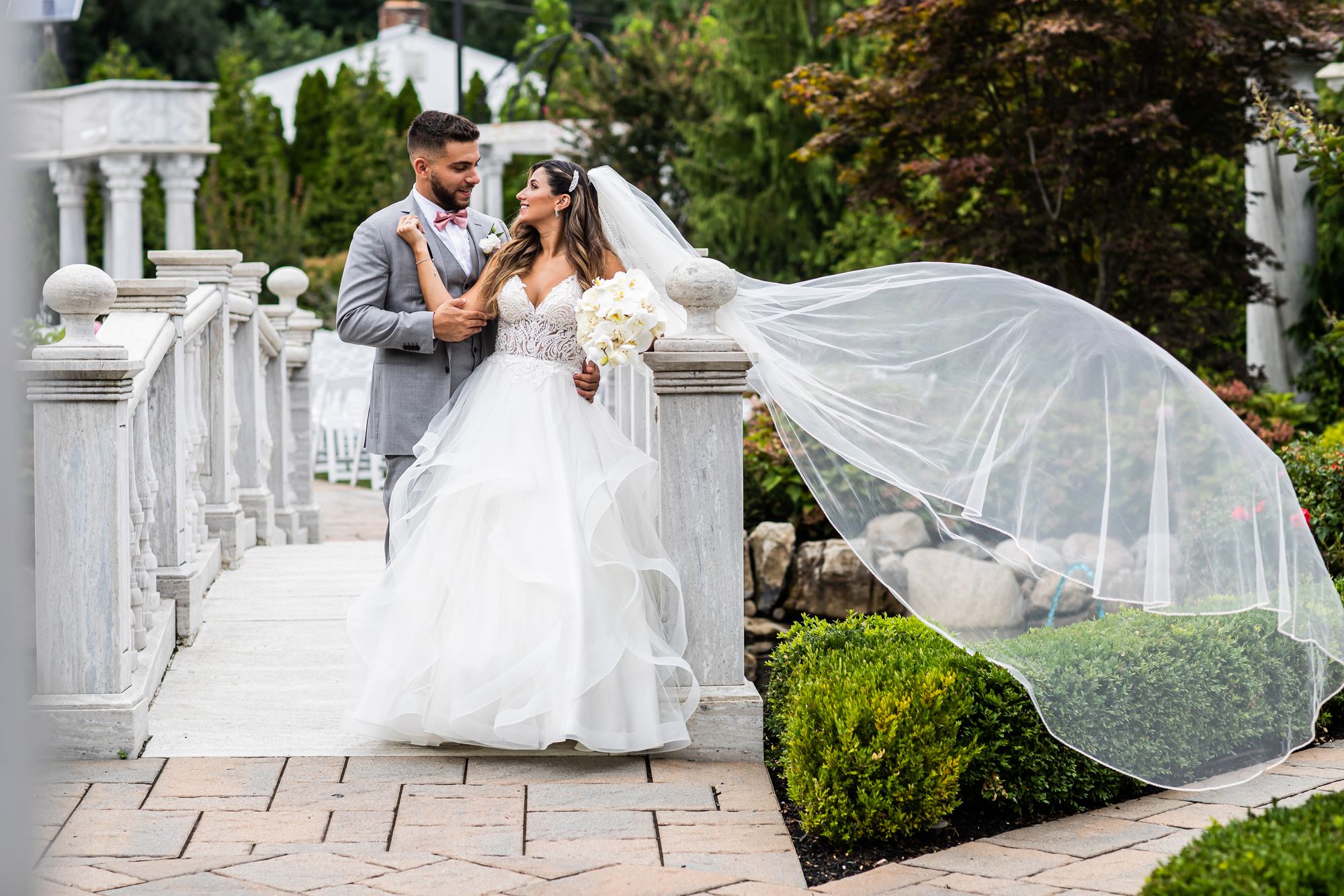 Bride and groom on the garden balustrade at The Merion, Cinnaminson, New Jersey